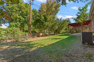 View of green lawn featuring a patio