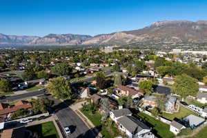 Aerial overview of property's location with a mountainous background and nearby suburban area