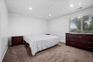 Bedroom featuring carpet floors, recessed lighting, and baseboard heating