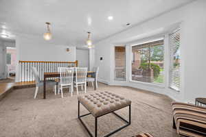 Living room with light carpet and a baseboard radiator