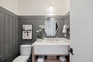 Half bath featuring vanity and toilet