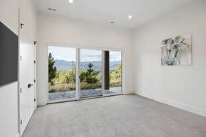 Unfurnished room with light colored carpet, recessed lighting, and a mountain view