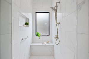 Bathroom featuring a marble finish shower