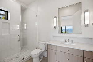 Bathroom featuring a stall shower and vanity