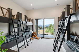 Bedroom with light carpet, recessed lighting, and a mountain view
