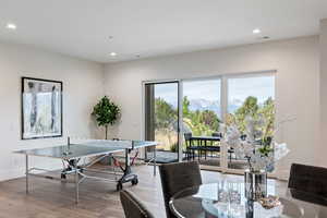 Recreation room featuring a mountain view, recessed lighting, and light wood-style flooring