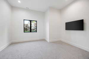 Unfurnished room featuring light colored carpet and recessed lighting