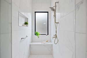 Bathroom with a marble finish shower