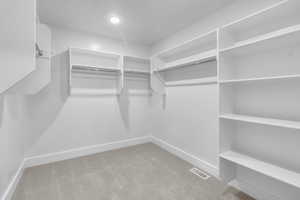 Spacious closet with carpet floors