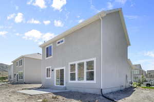 Back of property with a patio area and stucco siding