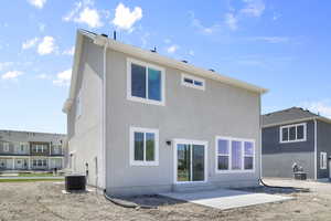 Rear view of house featuring a patio, stucco siding, and entry steps
