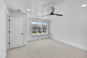 Unfurnished bedroom featuring carpet, ceiling fan, a textured ceiling, and recessed lighting