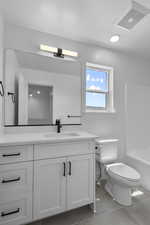 Full bath with vanity, light tile patterned floors, shower / bathtub combination, a textured ceiling, and recessed lighting