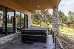 View of patio / terrace with a hot tub