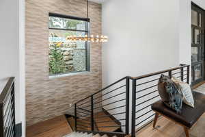 Stairs featuring wood finished floors