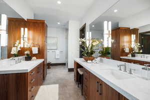 Full bath featuring two vanities and recessed lighting