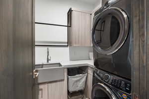 Washroom with stacked washing machine and dryer and cabinet space