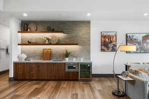 Bar with open shelves, modern cabinets, recessed lighting, wine cooler, and light wood-type flooring
