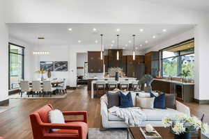 Living room featuring dark wood-style floors, recessed lighting, and beverage cooler