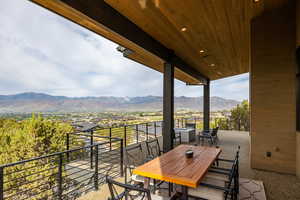 View of patio / terrace with a mountain view and outdoor dining area