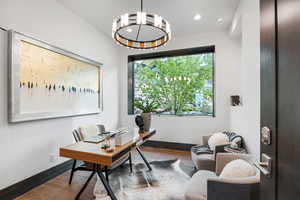 Office area featuring wood finished floors and recessed lighting