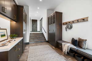 Mudroom with recessed lighting and light stone finish floors