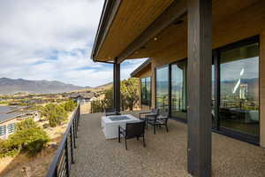 View of patio featuring a mountain view and an outdoor fire pit