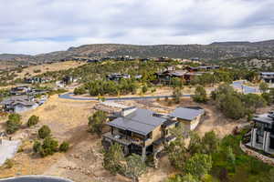 Aerial view of property's location featuring a mountainous background and nearby suburban area
