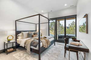 Bedroom featuring light carpet, recessed lighting, and access to exterior