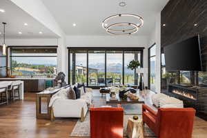 Living room featuring a chandelier, recessed lighting, dark wood-type flooring, and wine cooler