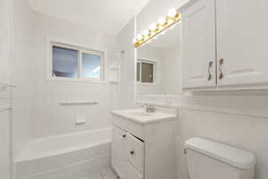 Full bathroom featuring shower / bathtub combination, vanity, and light tile patterned flooring