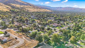 Aerial view of property's location with a mountainous background and nearby suburban area