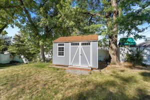 View of shed with a fenced backyard