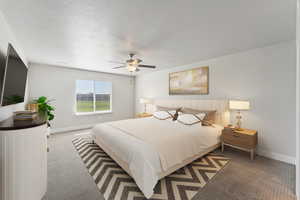 Carpeted bedroom with a textured ceiling and ceiling fan