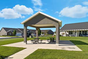 View of home's community with a patio, a yard, and a residential view