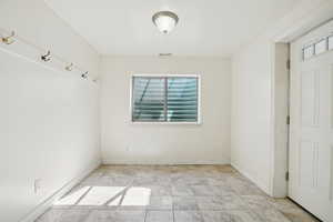 Empty room featuring baseboards