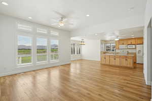 Unfurnished living room with recessed lighting, ceiling fan, and light wood finished floors