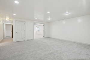 Spare room featuring light carpet and recessed lighting