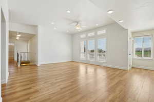 Unfurnished living room with light wood-type flooring, recessed lighting, and ceiling fan