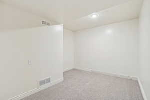Carpeted empty room featuring baseboards