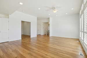 Unfurnished living room featuring light wood-style floors, recessed lighting, and a ceiling fan