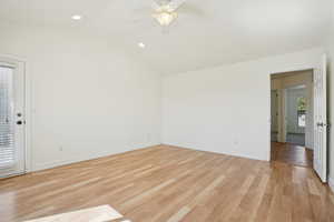 Unfurnished room featuring vaulted ceiling, light wood-type flooring, recessed lighting, and ceiling fan