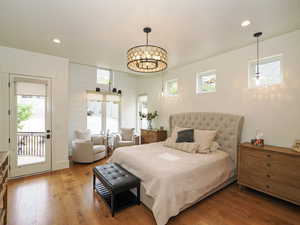 Bedroom featuring recessed lighting, wood finished floors, and access to outside