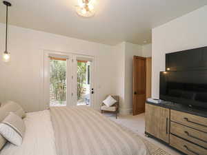 Bedroom featuring access to outside and light colored carpet