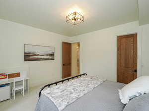 Bedroom featuring light colored carpet and baseboards