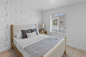 Carpeted bedroom featuring baseboards