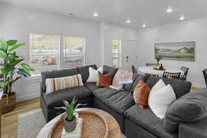 Living room with wood finished floors and recessed lighting