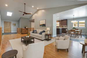 Living room featuring ceiling fan, light wood finished floors, recessed lighting, and high vaulted ceiling