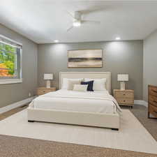 Carpeted bedroom with baseboards and ceiling fan