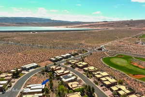 Aerial perspective of suburban area featuring a mountain backdrop and a desert landscape
